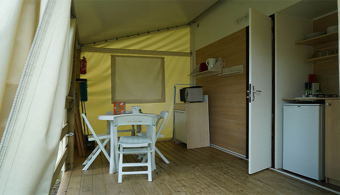 Cuisine équipée, table et chaises sur la terrasse du Bungalow Toilé